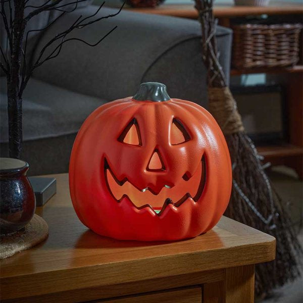 Jack-o'-lantern decoration on a wooden surface with a blurred background
