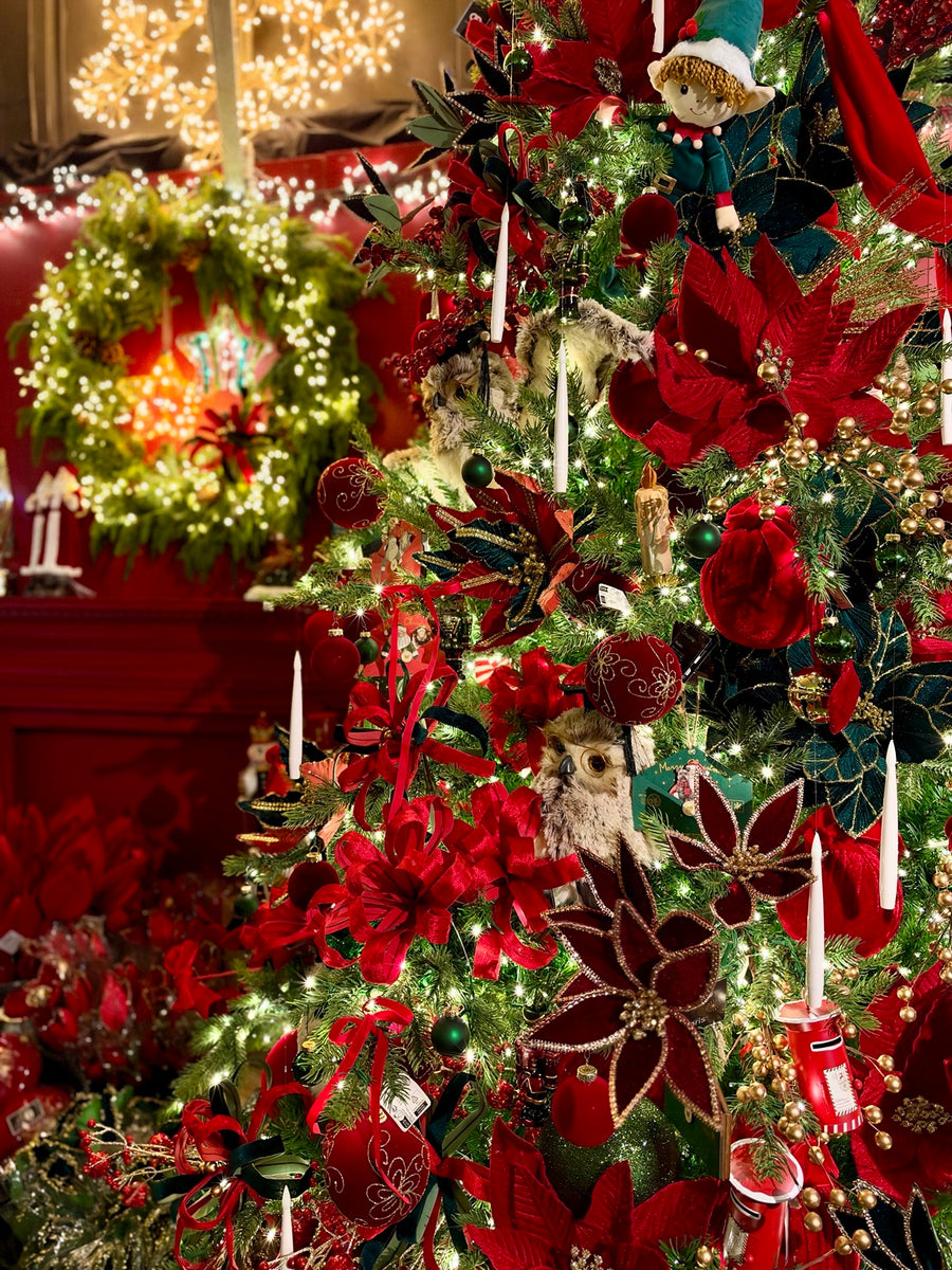 Luxury red and green decorated Christmas tree display at Southwood Garden Centre